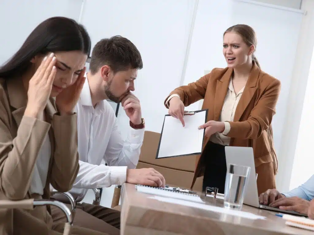 Manager lashing out at subordinates in work meeting.